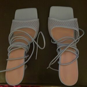 Brand new Blue lace up/strap open toed heels.